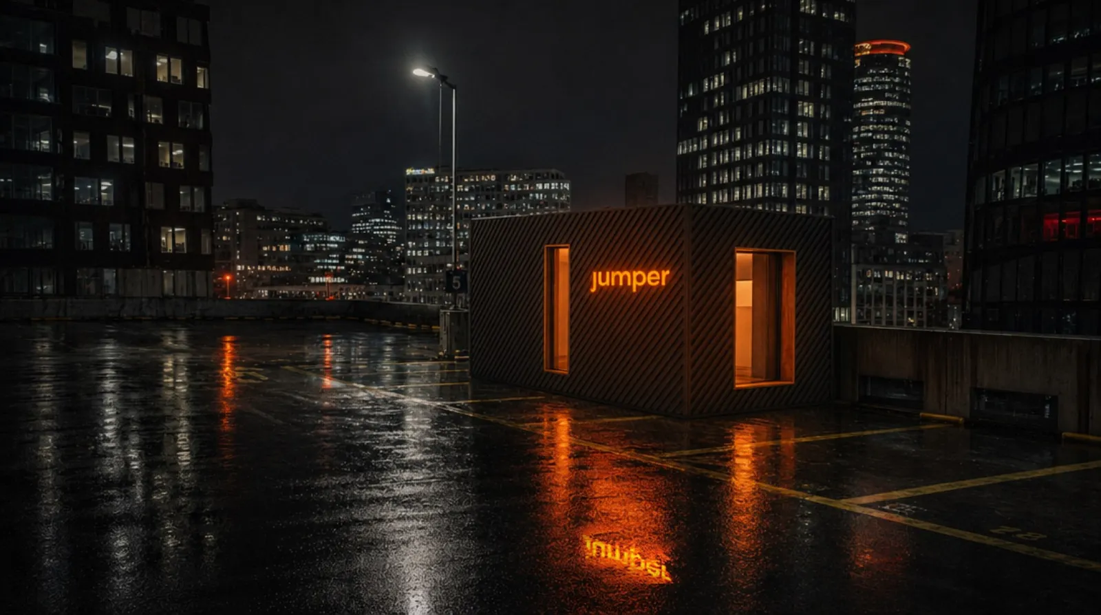 A single Jumper module with a lit orange wordmark on a rain-wet rooftop car park at night, office towers behind it